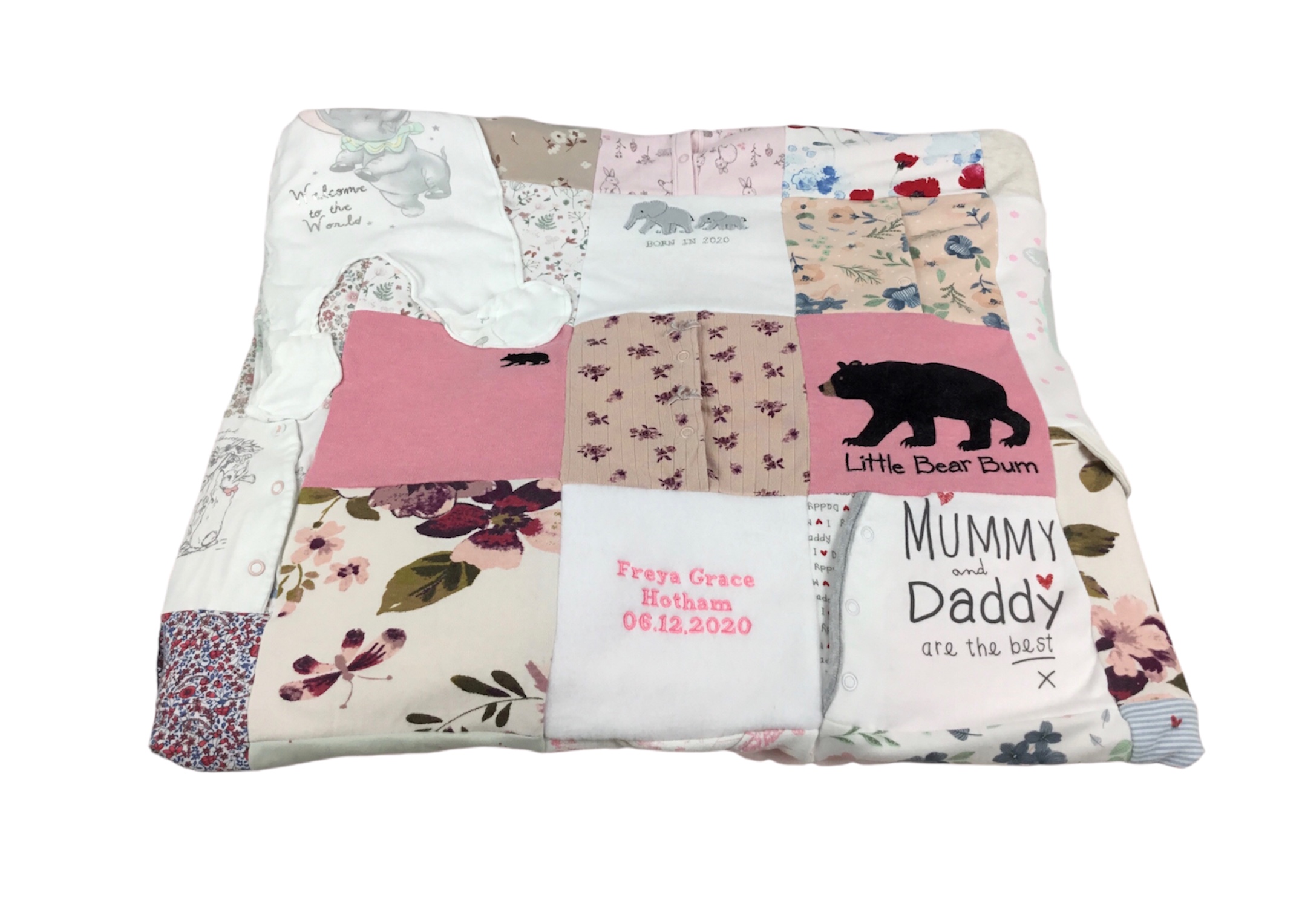 Baby clothes in pastel pinks handmade and personalized into a memory blanket keepsake